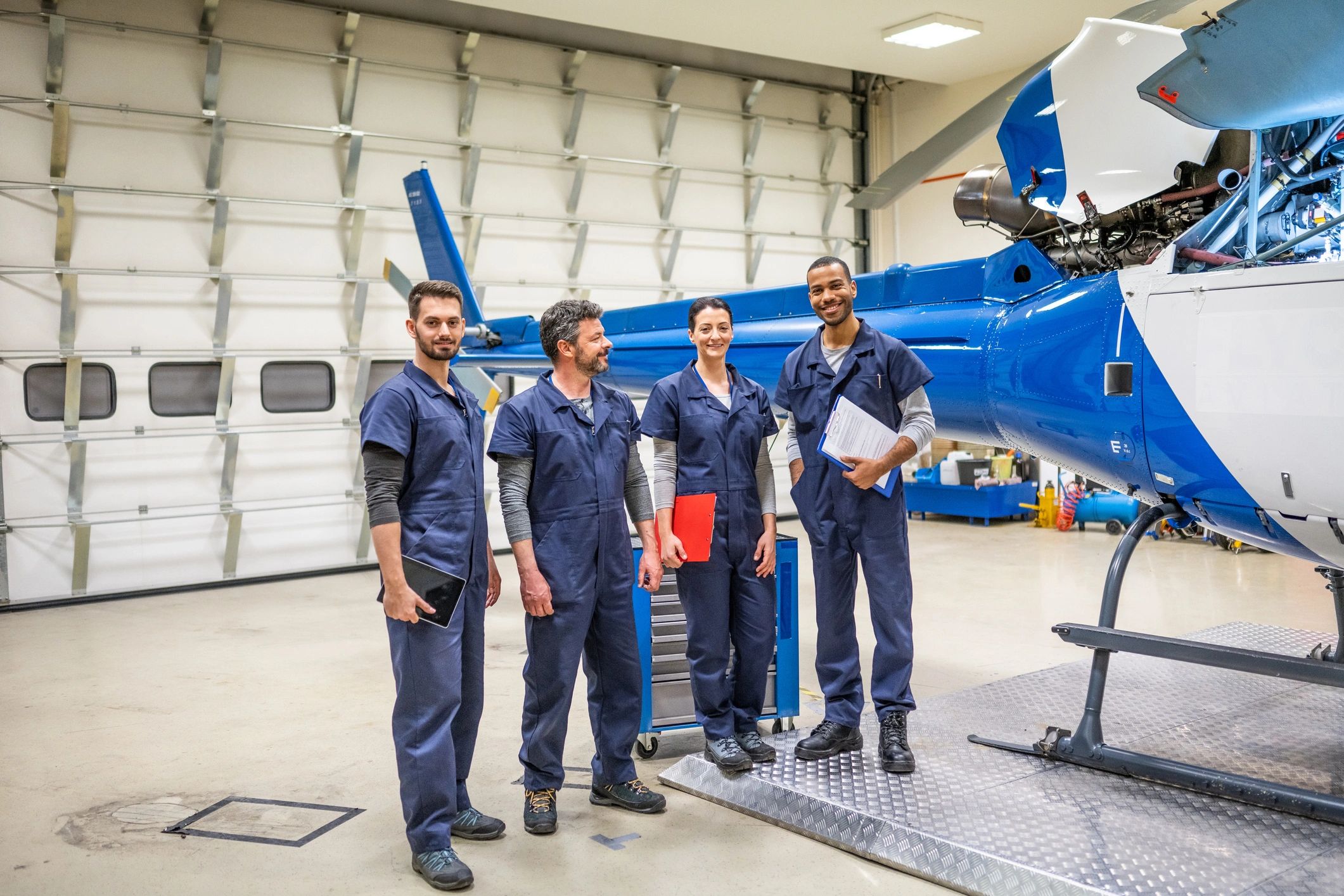 Aviation team standing together in an aircraft hangar