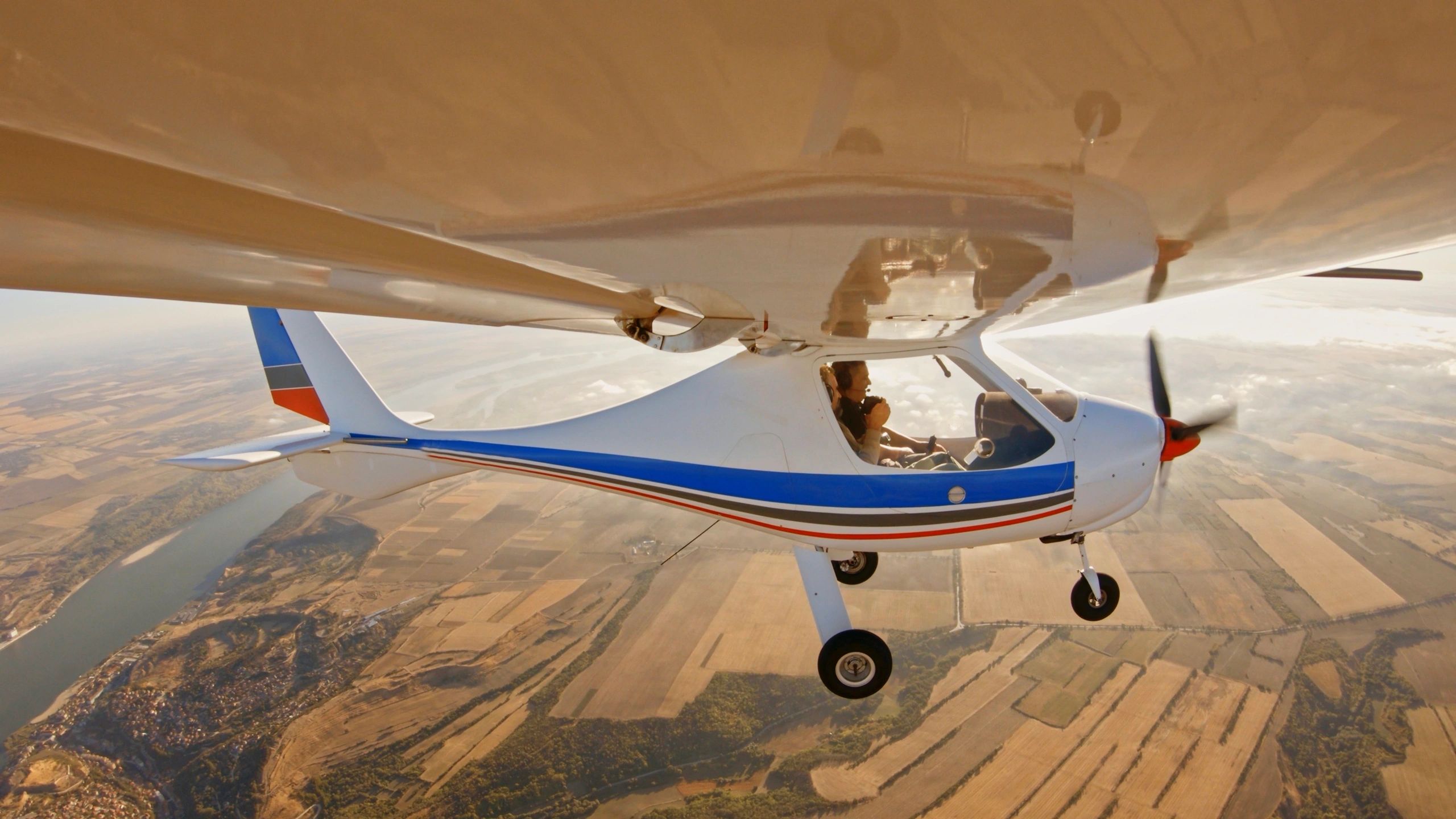 Small aircraft in flight over Colorado landscape