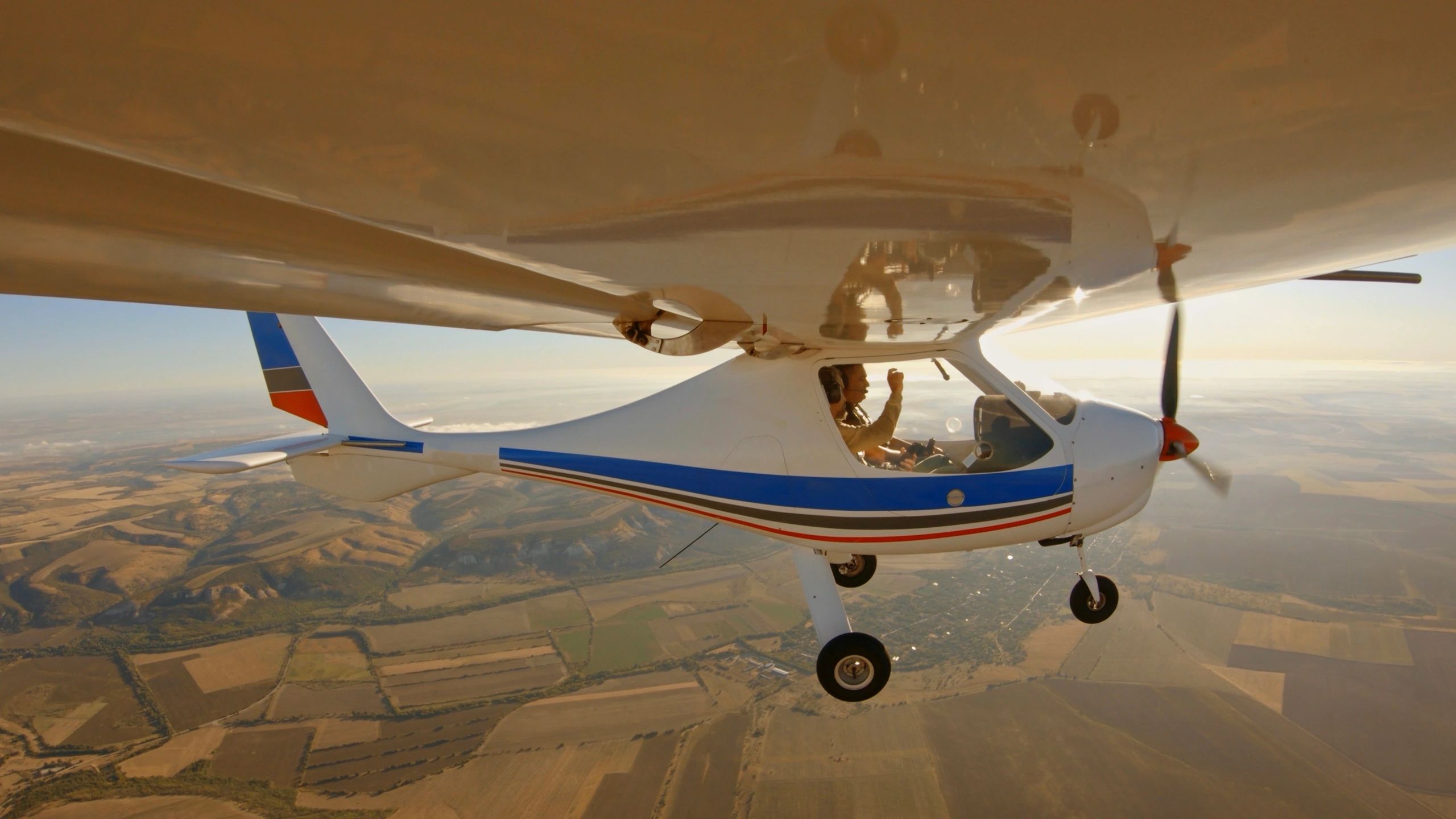 Small airplane in flight above the landscape
